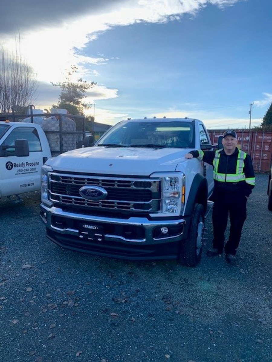 Man beside a white pickup truck