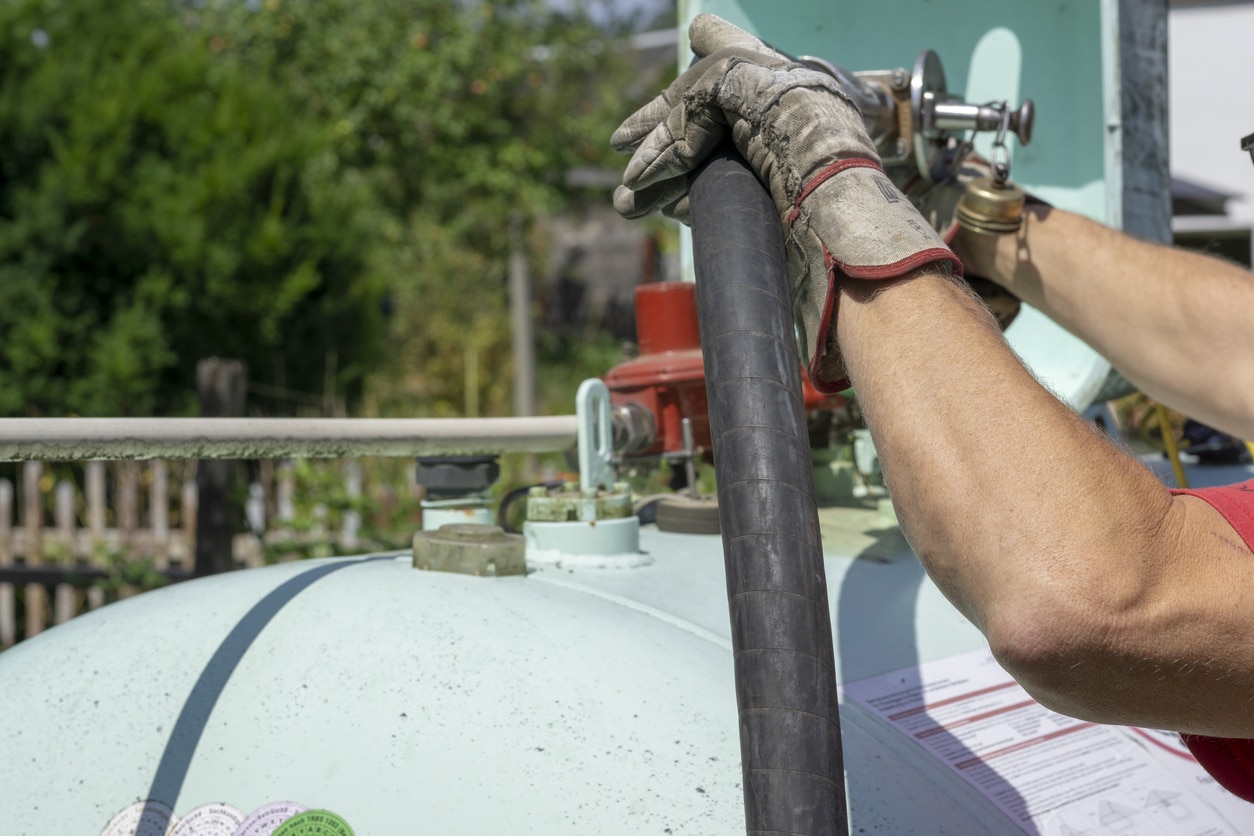 Person handling equipment with hose