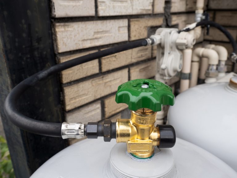 Gas cylinder with green valve and hose