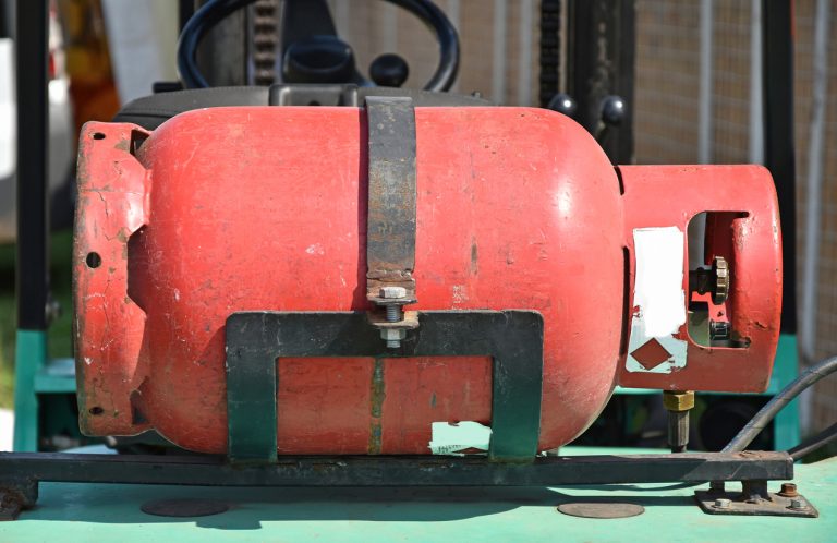Red gas cylinder on machinery